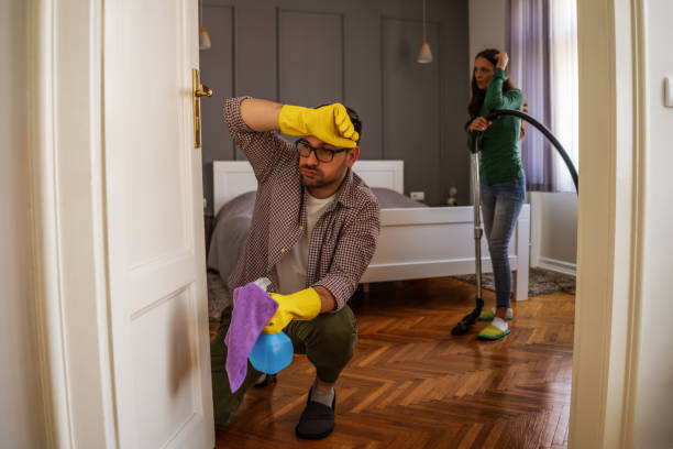 istock Couple cleaning their home 1219862076