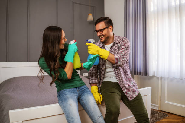 istock Couple cleaning their home 1219862170