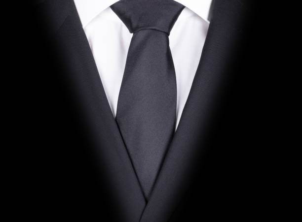 istock Man in a black suit with black tie, close-up 1219862190