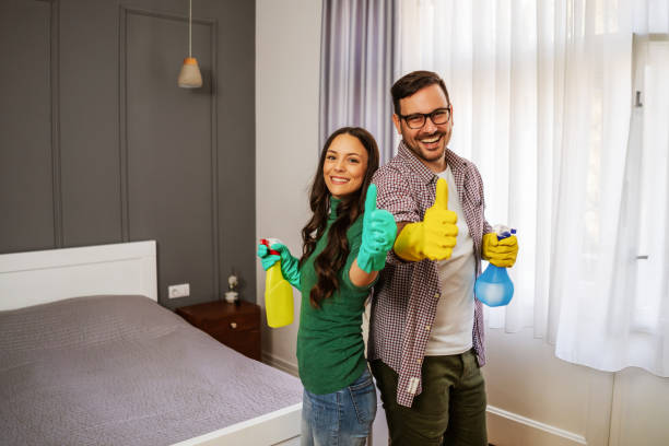istock Couple cleaning their home 1219862353