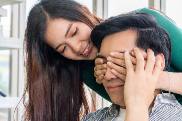 istock Young happy Asian couple having good time while stay at home 1219864089