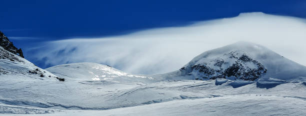 istock White winter mountains covered with snow in blue cloudy sky. Alps. Austria. 1219865695