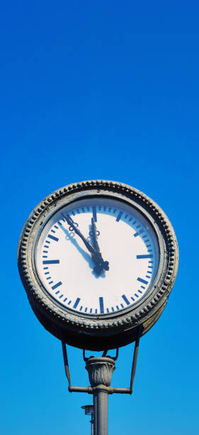 istock Old train station clock with blue sky in the background. 1219868339