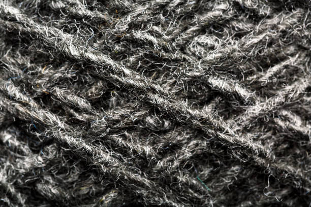 istock Wool yarn close-up gray threads for needlework in macro. Background texture fabric for knitting needle. 1219868377
