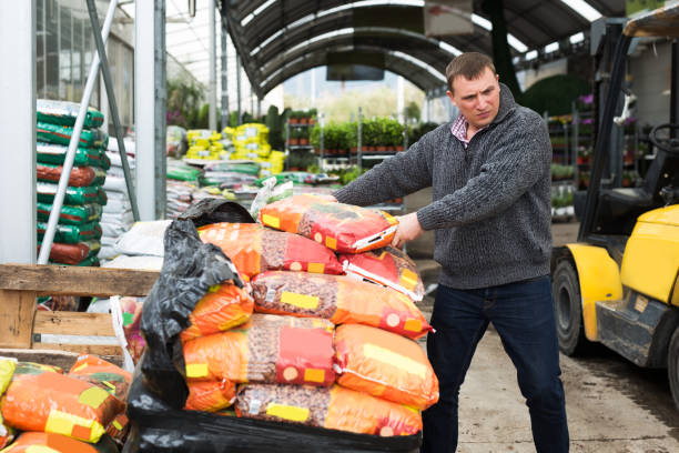 istock worker unloading garden substrates in gardening store 1219869596