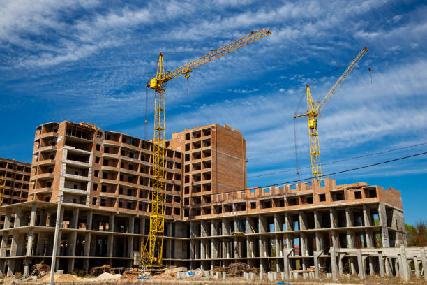 istock Work in progress on a new apartment block. Tall building under construction with cranes. Construction Site of New Building 1219870105