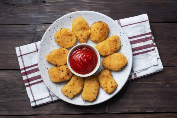 istock Fried chicken nuggets with tomato ketchup sauce. Wooden background. Copy space. 1219871126
