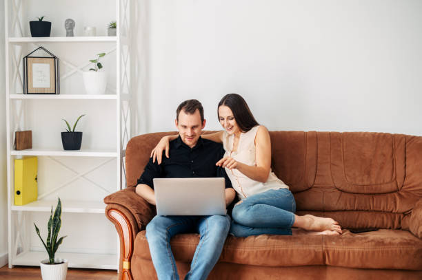 istock Young married couple on a sofa with a laptop 1219871355