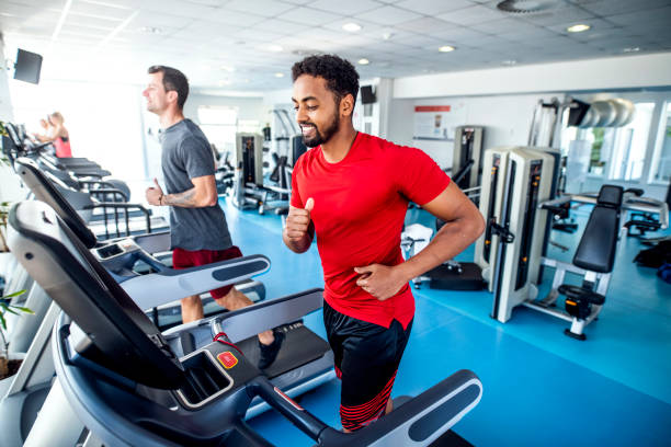 istock Fit and Focused Mid Adult Men Using Treadmills at Gym 1219871453