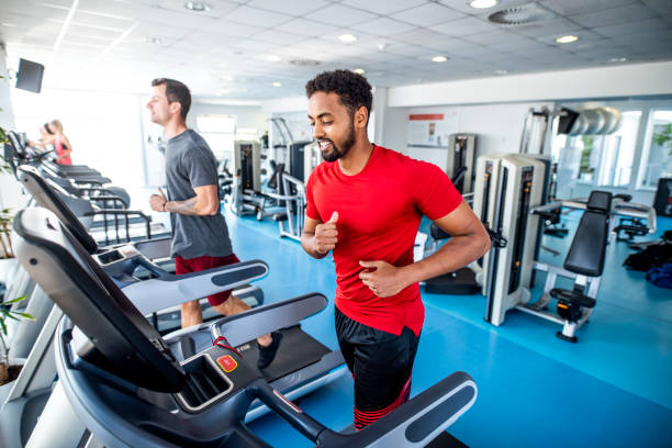 istock Fit and Focused Mid Adult Men Using Treadmills at Gym 1219871489