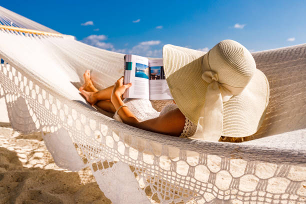 istock Reading a book in hammock on the beach! 1219874055