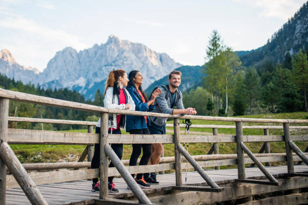 istock Three Hikers Pausing on Pedestrian Bridge to Enjoy View 1219874998