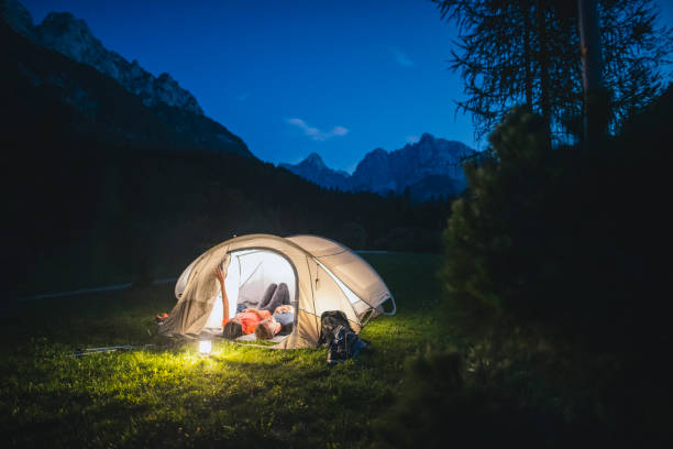 istock Relaxed Camping Couple Lying in Tent and Looking at Stars 1219875083