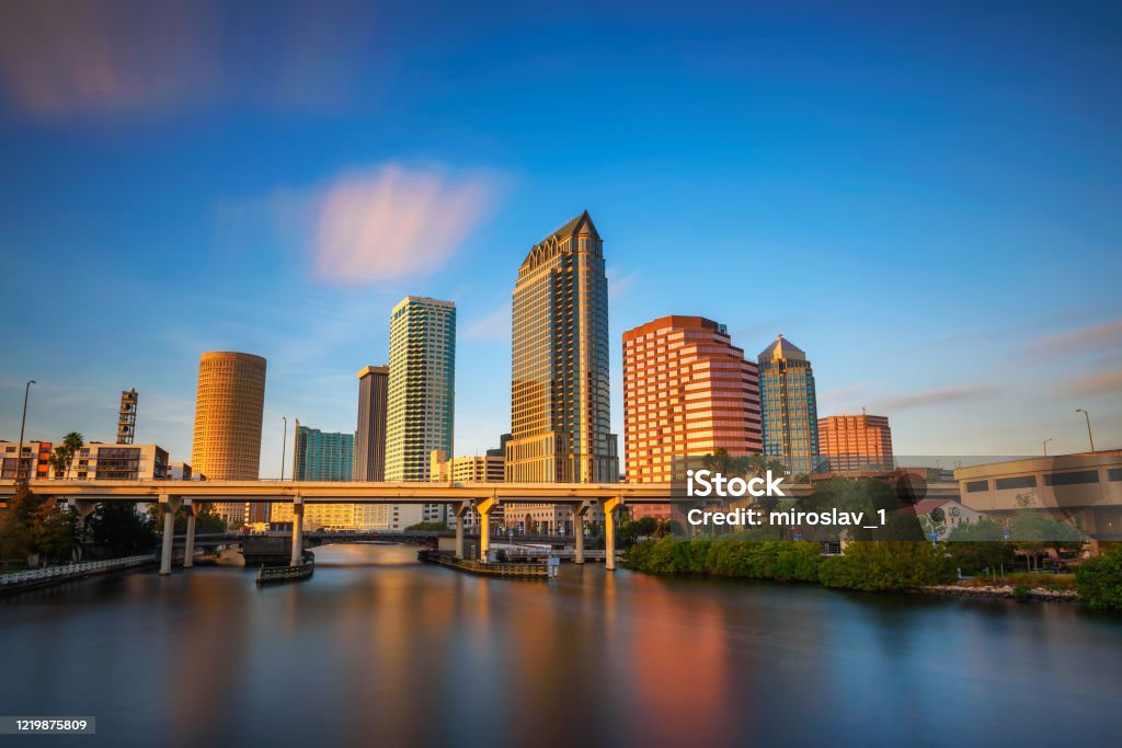 Tampa skyline at sunset with Hillsborough river in the foreground The skyline of downtown Tampa at sunset with Hillsborough river in the foreground. Long exposure. Tampa Stock Photo