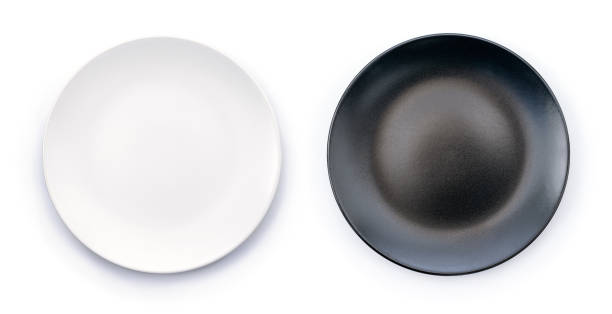 istock White and Black empty plates isolated on white background top view 1219875816