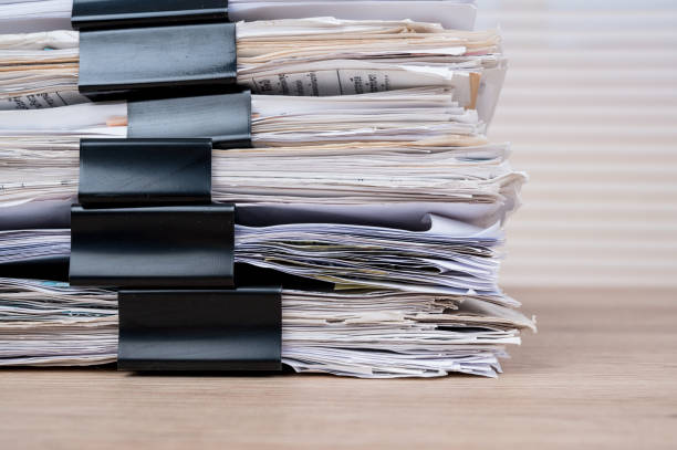 istock A black document clip that attaches to a desk. 1219878200