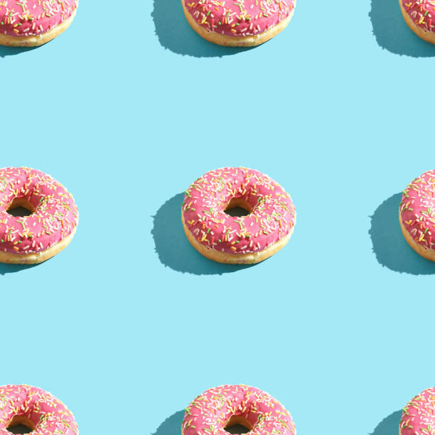 istock doughnut seamless pattern. Bright color. Tasty unhealthy food 1219879129