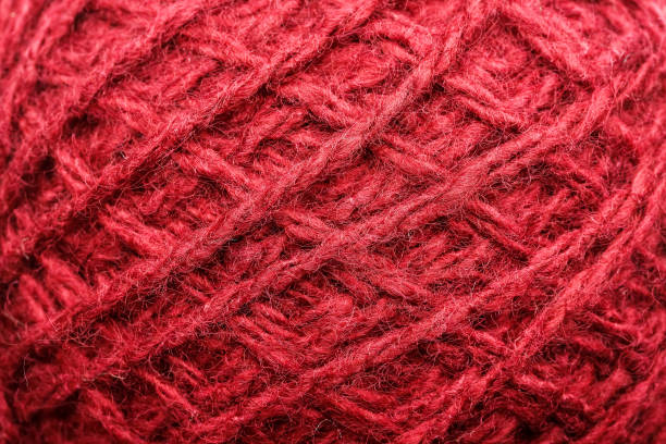 istock Wool yarn close-up colorful red thread for needlework in macro. 1219879907