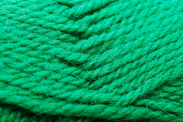 Wool yarn close up colorful aquamarine threads for needlework in macro. Background texture fabric for knitting needle. Full screen wool yarn.