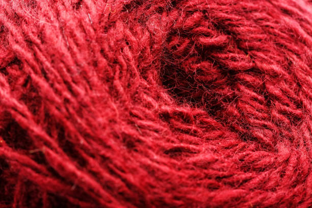 istock Wool yarn close-up colorful red thread for needlework in macro. 1219880461