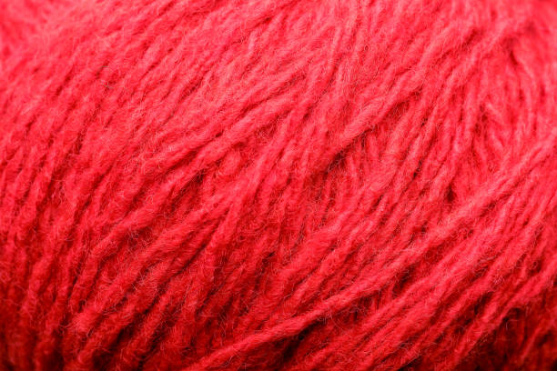 istock Wool yarn close-up colorful red thread for needlework in macro. 1219880497
