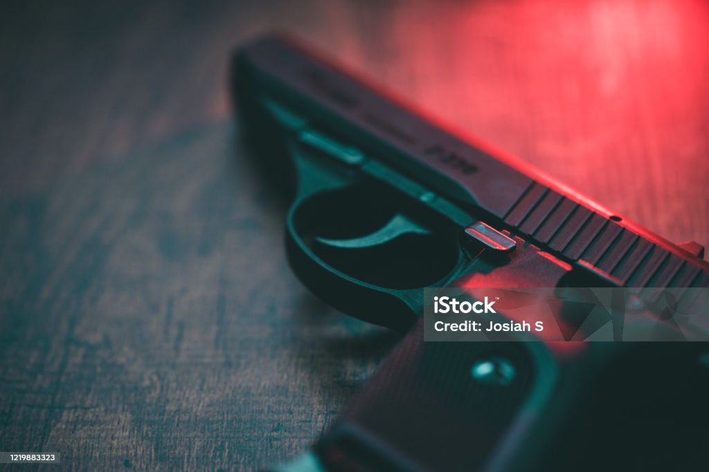 Red lighting hand gun Semi automatic hand gun and red light. Gun Stock Photo