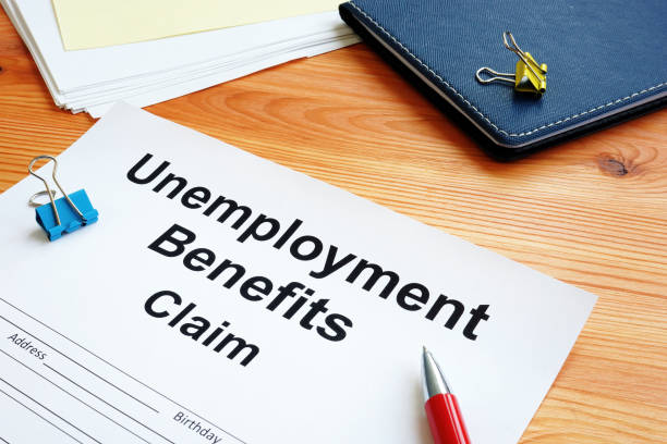 istock Unemployment benefits claim and stack of documents. 1219883466