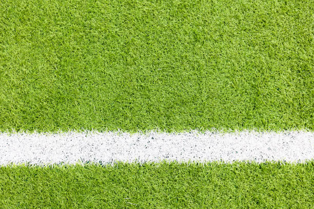 istock White stripe on the green soccer field from top view 1219885024
