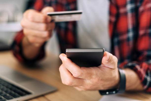 istock Online shopping from home office using smartphone and credit card 1219885970