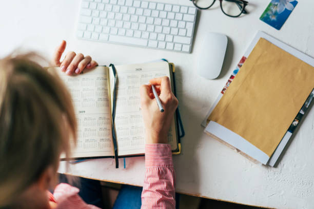 istock top view woman writes on calendar 1219886066