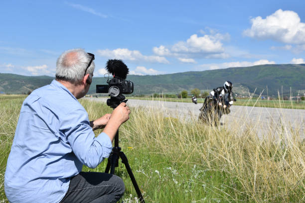 istock Man filming motor racing 1219886283