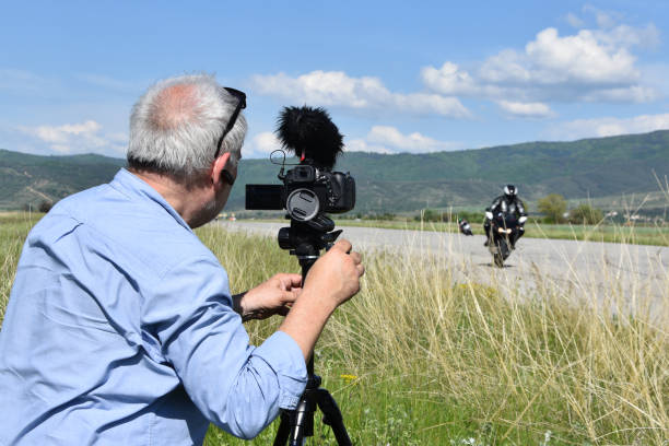 istock Man filming motor racing 1219886292