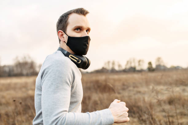 istock Guy in a medical mask is jogging 1219887904