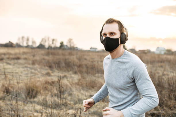 istock Guy in a medical mask is jogging 1219887905