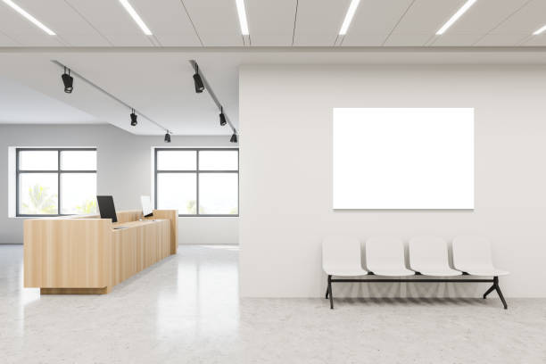 istock Poster and chairs in hospital hall with reception 1219889296