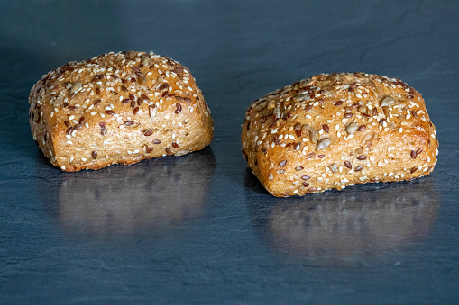 Loaf of bread with sesame seeds isolated on a dark background