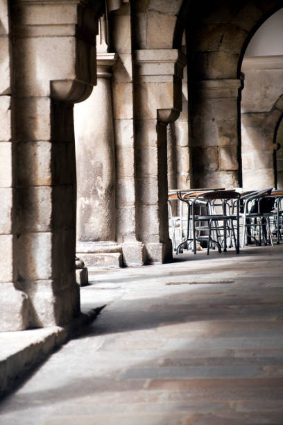 istock Street view in Santiago, stone arches with empty sidewalk cafe 1219891909