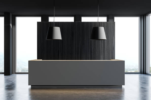 istock Gray reception desk in dark wooden office hall 1219892126