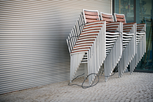 Stacked chairs of a closed sidewalk cafe