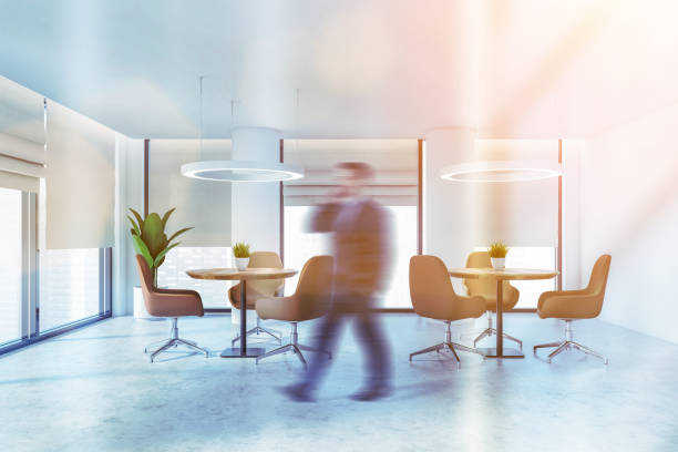 istock Man walking in office lounge or cafe 1219893401