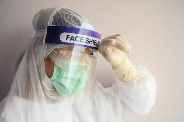 istock Nurse having headache and tired while wearing PPE suit for protect coronavirus disease. 1219893413