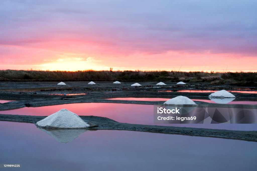 Sunset on salt marshes - Guerande, Brittany Colored sunset on salt marshes, an ancestral and old tradition in this country - Guerande, Brittany Guerande Stock Photo