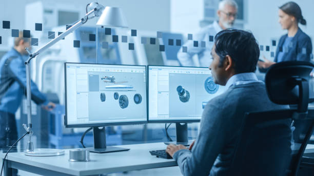istock Modern Factory Office: Automotive Engineer Working on PC with Screen Showing 3D Car Concept Made in CAD. Workshop: Workers Use High-Tech Industrial CNC Machinery, Program Robot Arm, Have Meeting 1219894319
