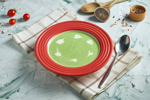 istock Diet broccoli cream soup with cream in a composition with ingredients on a gray background. Healthy cream soup green 1219895041