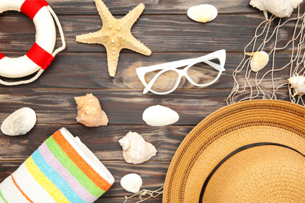 istock Beach accessories with palm leaves on brown background 1219895797