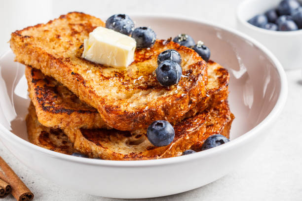 istock French toasts with berries and honey in white plate. 1219896568