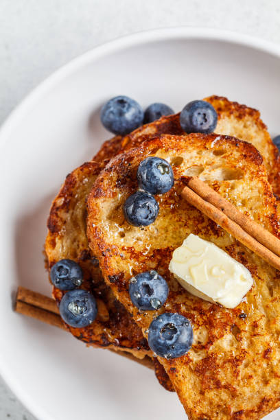 istock French toasts with berries and honey in white plate. 1219896645