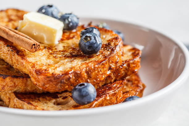 istock French toasts with berries and honey in white plate. 1219896664
