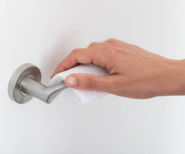 istock A hand opens a door with the help of a towel to avoid spreading viruses 1219896689