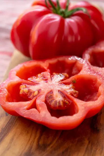 Two sweet pink monterosa tomatoes close up